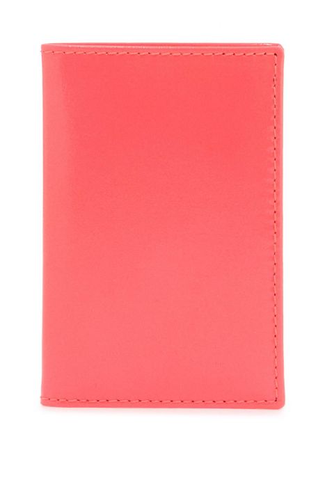 comme des garcons wallet portafoglio compatto unisex rosa fluo in pelle di capra